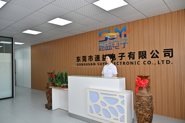 Dongguan Suyi Electronics reception area with company logo and front-desk team member